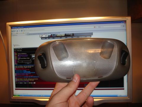 1996 Ford F-150 - Overhead dome light assembly held in front of a computer monitor.