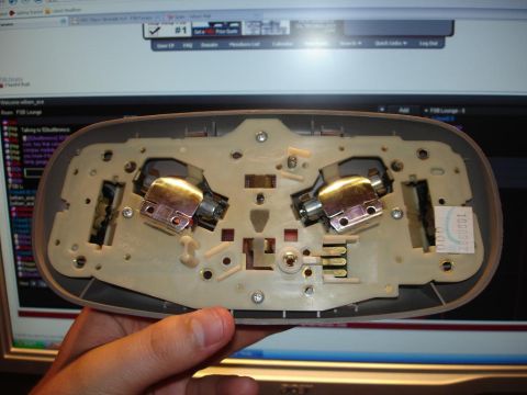 1996 Ford F-150 - Close-up of a vehicle's overhead console light assembly, showing the internal wiring and bulb sockets.