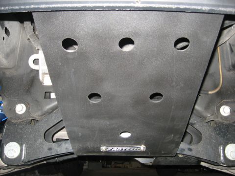 1979 Ford Bronco - This image shows the underside of a vehicle, focusing on a black skid plate with a prominent Fabtech logo.