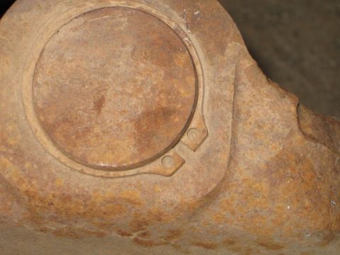 1995 Ford Bronco - Close-up of a corroded metal component, possibly a ball joint housing.