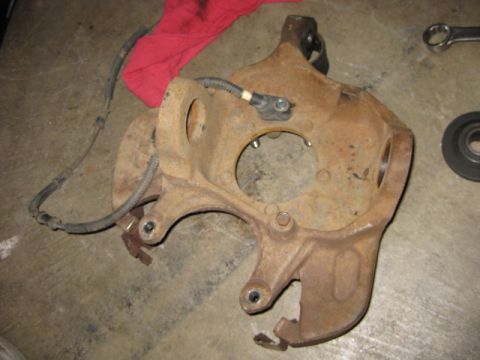 1995 Ford Bronco - This is a rusted steering knuckle with an ABS sensor and brake line.