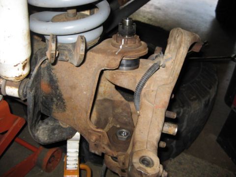 1995 Ford Bronco - This photo shows a vehicle's suspension system, specifically a ball joint assembly, with visible rust and wear.