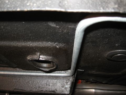 1968 Shelby GT500 - A close-up view of the underbody reveals a metal fuel line and a damaged section of the chassis.