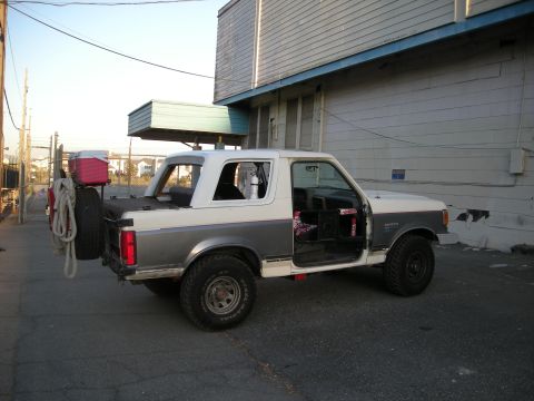 1991 Ford Bronco - This 1991 Ford Bronco is equipped with a rear-mounted spare tire and a cooler, ready for adventure.