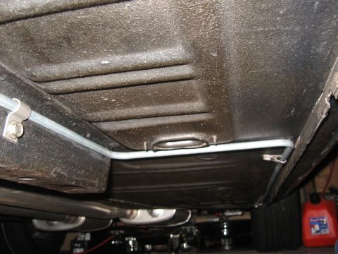 1968 Shelby GT500 - The underbody of a vehicle, focusing on the fuel lines and exhaust components.