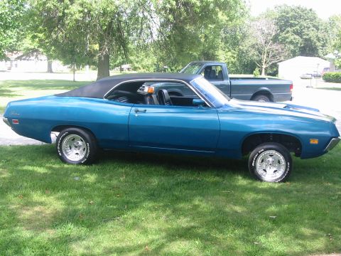 1970 Ford Fairlane - A blue 1970 Ford Fairlane convertible is parked on a grassy lawn with a pickup truck behind it.