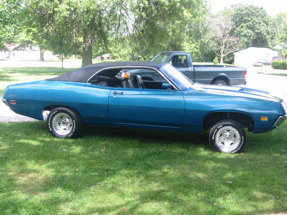 Blue 1970-71 Ford Torino two-door hardtop parked on grass