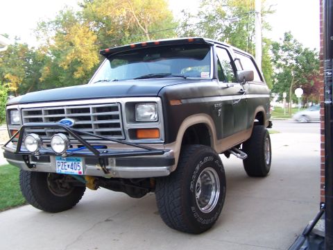 1986 Ford Bronco - This lifted Ford Bronco features a custom front bumper with auxiliary lights and a visor above the windshield.