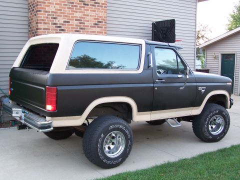 1986 Ford Bronco - This 1986 Ford Bronco features a two-tone black and tan paint scheme with a removable tan topper.