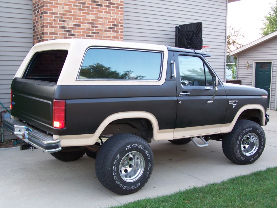 Black and tan 1986 Ford Bronco rear three-quarter view