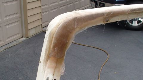1979 Ford Bronco - Close-up of a fiberglass part, showing construction details and fasteners. A vehicle is visible in the background.