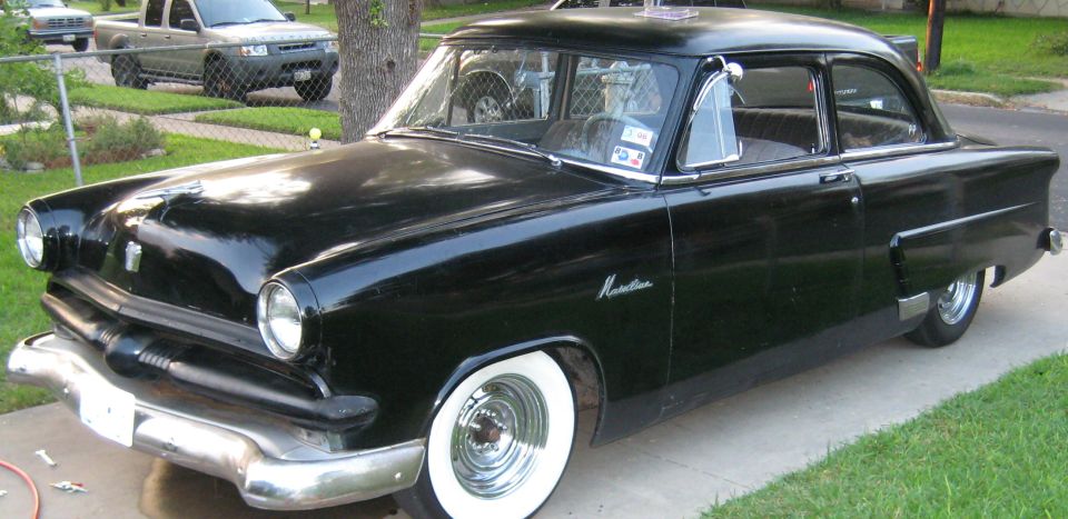 Black 1953 Lincoln-style sedan with Monterey badge and wide whitewall tires