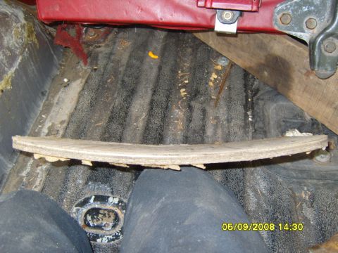 1989 Ford Bronco - A curved, worn brake pad is shown resting on the ribbed floor of a vehicle's interior, possibly a truck or SUV. The vehicle appears to be o…