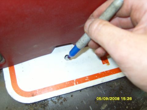 1989 Ford Bronco - A hand writes on a white label with orange trim.