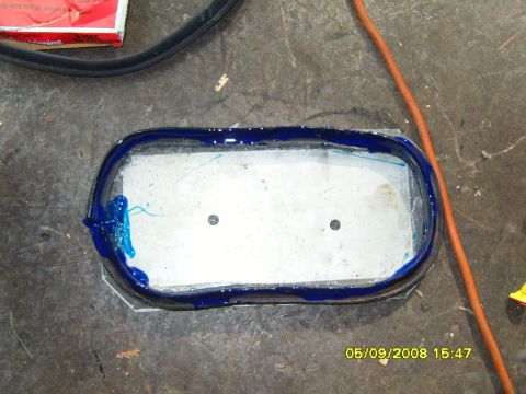 1989 Ford Bronco - Metal part with blue sealant applied, ready for repair or installation.