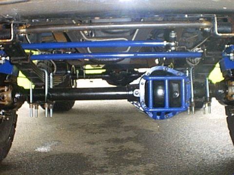 1995 Ford Bronco - Vehicle undercarriage with custom blue suspension parts and a reinforced differential cover.