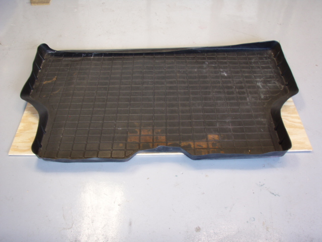 I used 3/8 inch plywood for the base.  I used my cargo mat as a template to cut out the wheel wells.