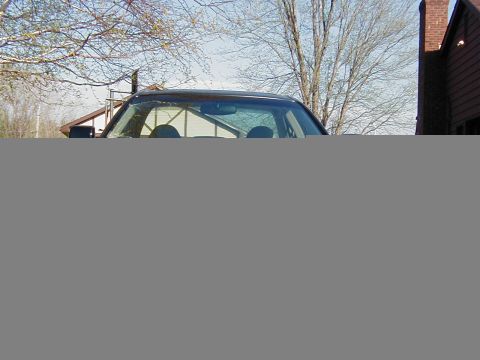 1997 Ford Taurus - Interior view of a car, with a reflection on the windshield showing the surroundings.