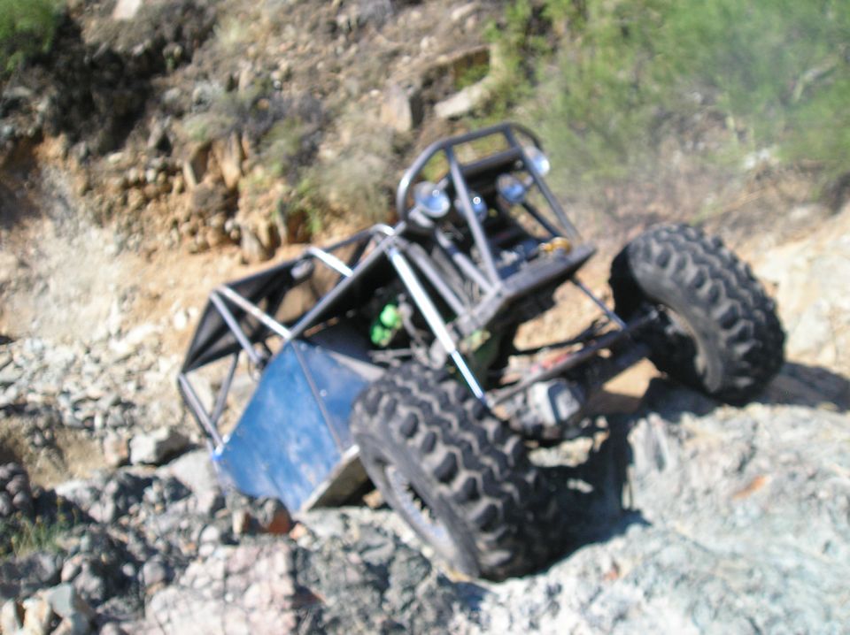 Custom off-road buggy on a rocky slope.