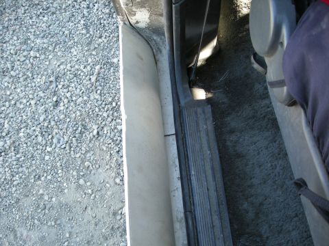 1991 Ford Bronco - Close-up view of the interior door sill and carpet area.