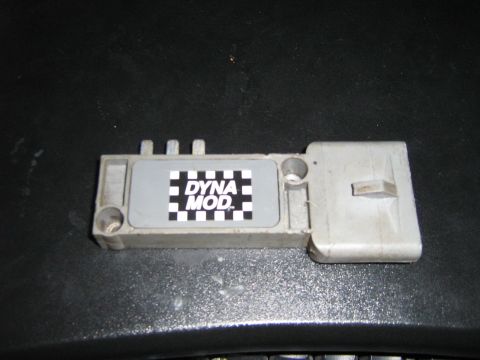 1990 Ford Bronco - A close-up view of an electronic ignition control module with a checkered label.