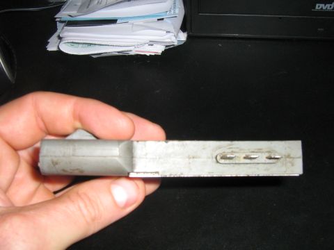 1990 Ford Bronco - Close-up of an automotive electrical connector being held by a hand.