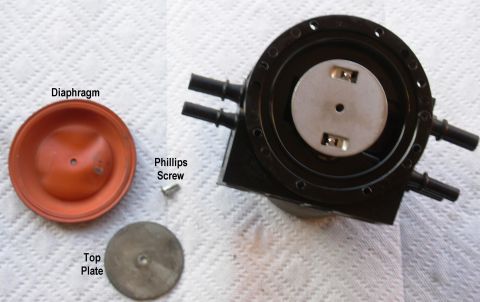 1983 Ford Bronco - Dual Function Reservoir Diaphragm Without distorting the diaphragm, remove the phillips screw from the diaphragm top plate & lift them off…