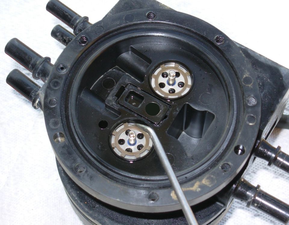 Dual Function Reservoir Rings

Using a clean, sharp pick, carefully pry each tab of the lock rings up one-at-a-time working slowly around each ring to release it without bending it.  Avoid scarring the valve bores.