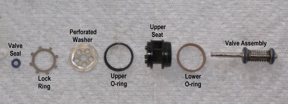 Dual Function Reservoir Switching Valve
IF THE IMAGE IS TOO SMALL, click it.

Without distorting any rubber parts, slide each component off the top end of the valve stem, keeping them in order.

If the valve assembly must be disassembled, remove the E-ring from the bottom end & carefully slide each component off.  Do not use silicone grease anywhere near the fuel system.  The only acceptable lubricant is clean motor oil.