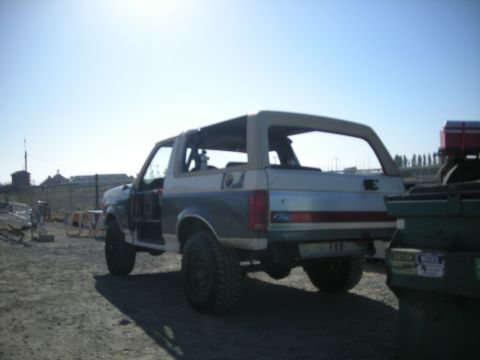 1991 Ford Bronco - Rear view of a 1991 Ford Bronco with its top removed, parked outdoors.