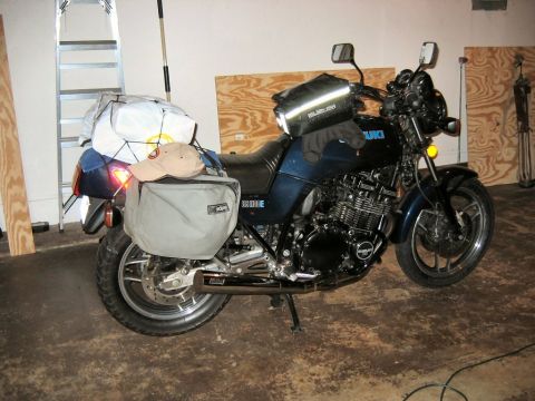 1985 Ford LTD Crown Victoria - Photo of a Suzuki motorcycle parked in a garage, an actual vehicle photo rather than a technical document.