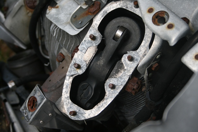 Close-up of an engine's connecting rod and piston assembly, showing rust.