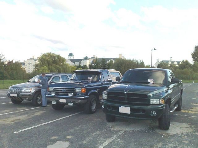 Jeep, Ford and Dodge trucks parked together in a lot