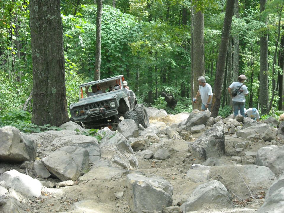 Ford Bronco on a rocky trail with spectators watching