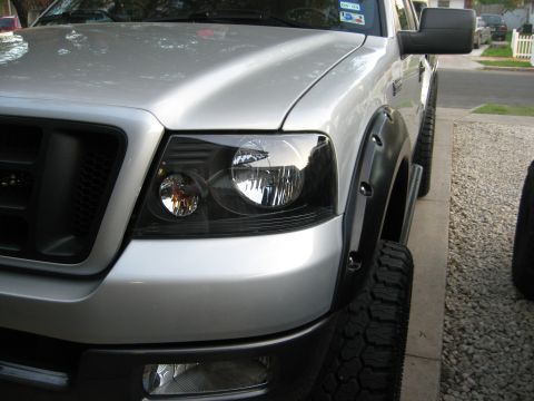 1979 Ford Bronco - A silver pickup truck is shown from the front quarter angle, highlighting its fender flares and headlights.