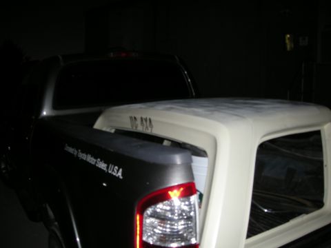 1991 Ford Bronco - A pickup truck bed is loaded with a white camper shell. Text indicates Toyota distribution and 'DC 4X4'.