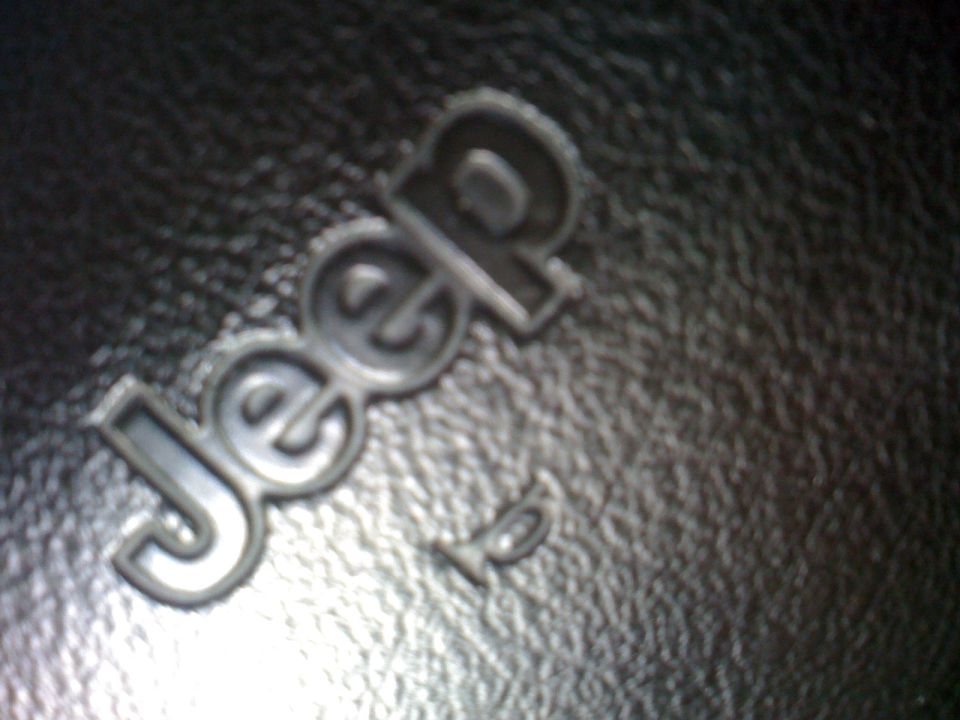 Embossed Jeep logo on black textured surface