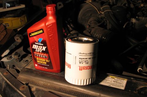 1994 Ford Bronco - Motorcraft FL-1A oil filter and Valvoline MaxLife transmission fluid are shown on a vehicle's engine bay.