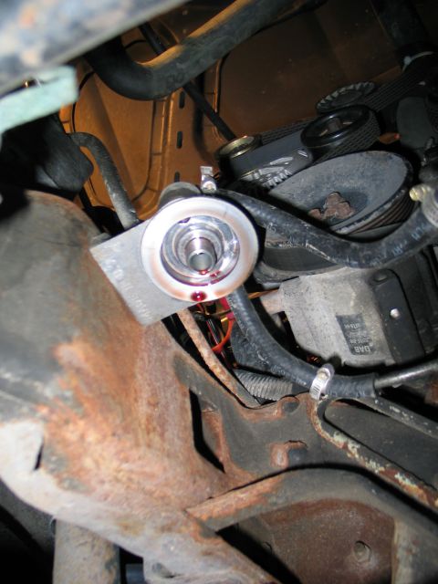 1994 Ford Bronco - Close-up view of an engine oil filter housing, showing some red fluid leakage.
