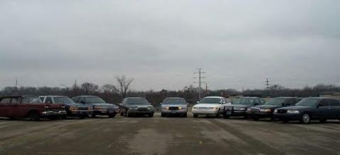 1988 Ford Crown Victoria - A lineup of Ford Crown Victoria police cars and other sedans gathered for a meet.