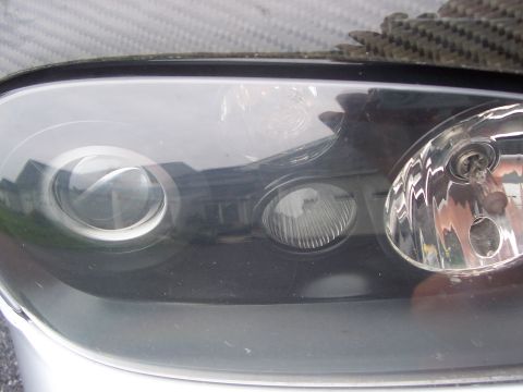 1993 Ford Probe - A detailed view of a vehicle's headlight assembly, showing internal components and the surrounding trim.