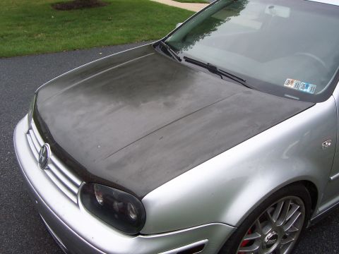 1993 Ford Probe - This silver car features a dark hood and tinted headlights, with license plate stickers visible on the windshield.