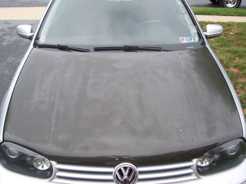 1993 Ford Probe - Front view of a Volkswagen with a carbon fiber wrapped hood and a chrome grille emblem.