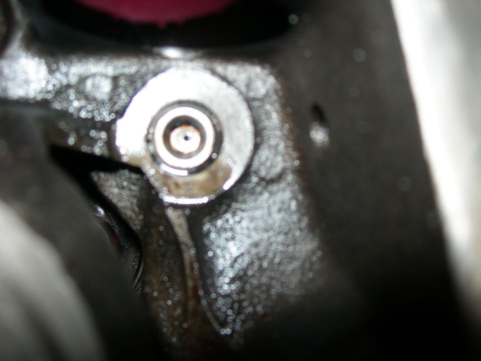 Close-up of a metal engine part with a circular fitting.