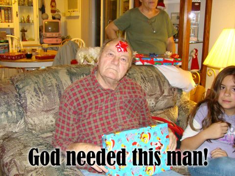 1989 Ford Bronco - A man with a red bow on his head sits on a couch holding a gift. A young girl sits next to him, and another person stands behind them. The…