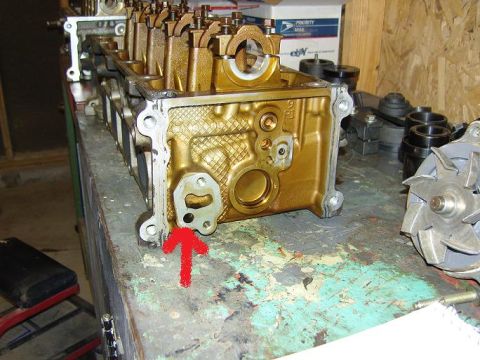2007 Ford Mustang - Photograph of a cylinder head with a hand-drawn red arrow, a physical part not a technical document.