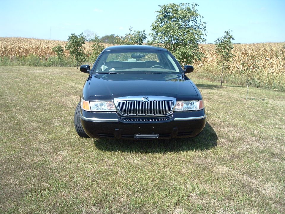Black 2001 Mercury Grand Marquis front view parked on grass with cornfield background