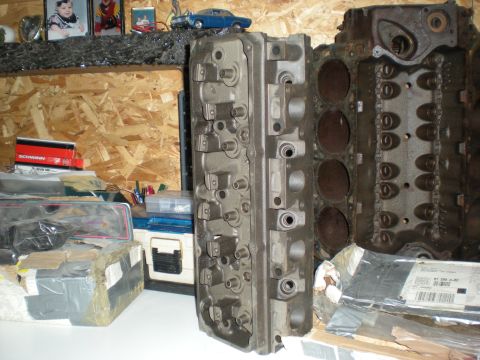 1974 Ford Ranchero - Two large cast iron engine parts are displayed on a shelf. The part on the left is a cylinder head, and the part on the right is an engine…