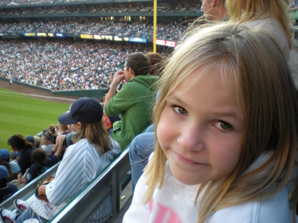 Girl smiling at a baseball game