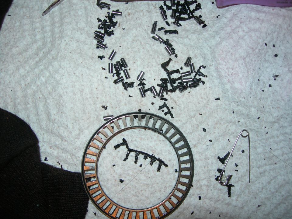 This is a bearing out of the t-case.  The black stuff is RTV.